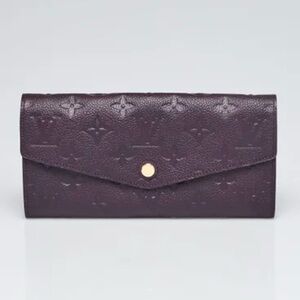 LOUIS VUITTON
Aube Monogram Empreinte
Leather Curieuse Wallet